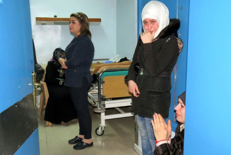 Women wait anxiously in a hospital for news of loved ones after a rocket hit a busy shopping area in the Jaramana area of Damascus, in one of the deadliest rebel attacks on the Syrian capital