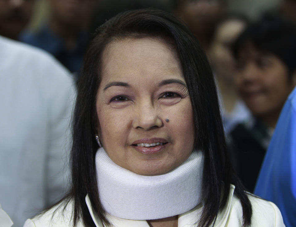 FILE - In this Feb. 23, 2012 file photo, former Philippine President and now Congresswoman Gloria Macapagal Arroyo arrives at a Pasay City Court for her arraignment on electoral fraud charges in Manila. The Philippine anti-graft court on Thursday, Oct. 4, 2012, ordered the arrest of Arroyo in the third corruption investigation against her, this one accused her of misusing $8.8 million in state lottery funds during her last years in office. (AP Photo/Bullit Marquez, Pool, File)