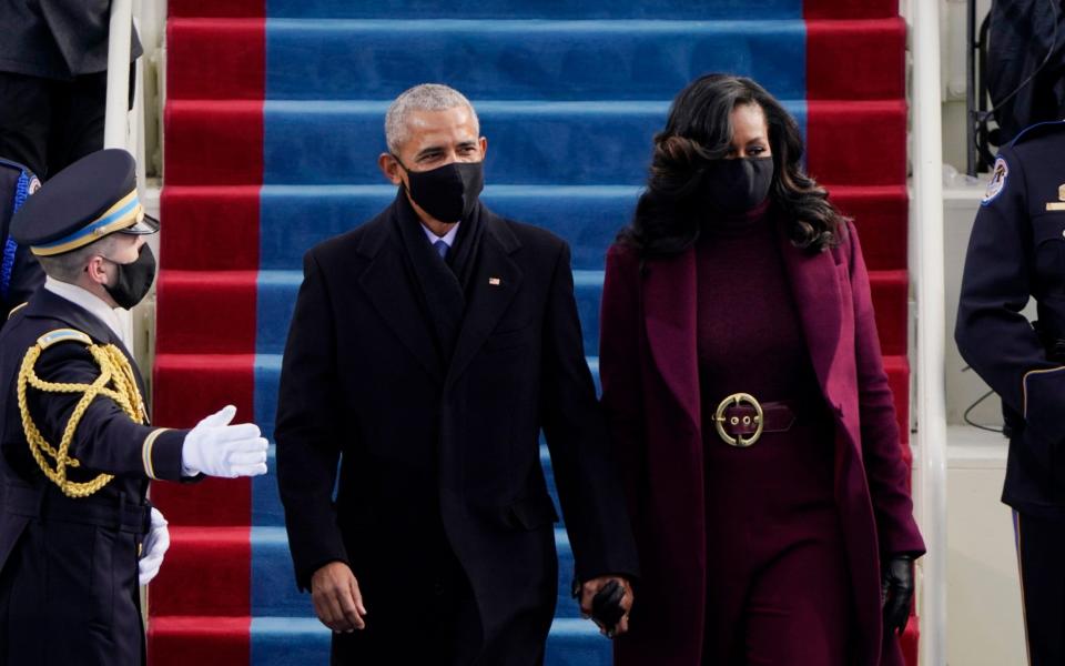 Former President Barack Obama and his wife Michelle arrive for the 59th Presidential Inauguration at the U.S. Capitol for President-elect Joe Biden in Washington, Wednesday, Jan. 20, 2021 - AP