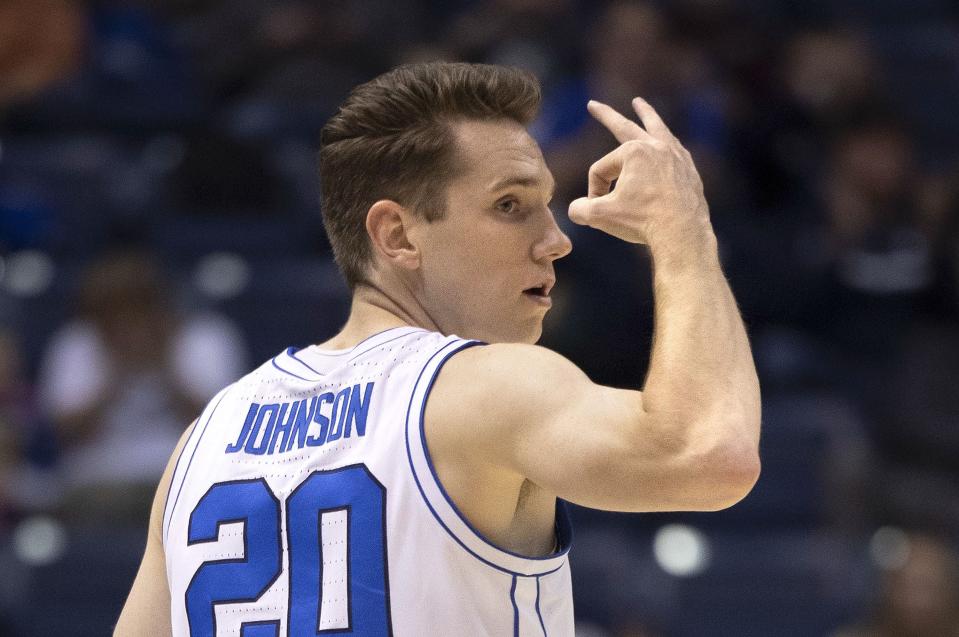 Brigham Young Cougars guard Spencer Johnson (20) holds up three fingers after scoring in the game against San Diego State at BYU’s Marriott Center in Provo on Friday, Nov. 10, 2023.