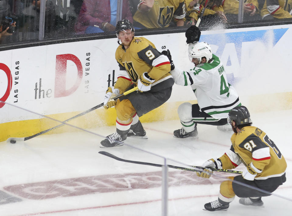 Vegas Golden Knights center Jack Eichel (9) defends the puck from Dallas Stars defenseman Joel Hanley (44) in the third period during Game 5 of the NHL hockey Stanley Cup Western Conference finals Saturday, May 27, 2023, in Las Vegas. (AP Photo/Ronda Churchill)