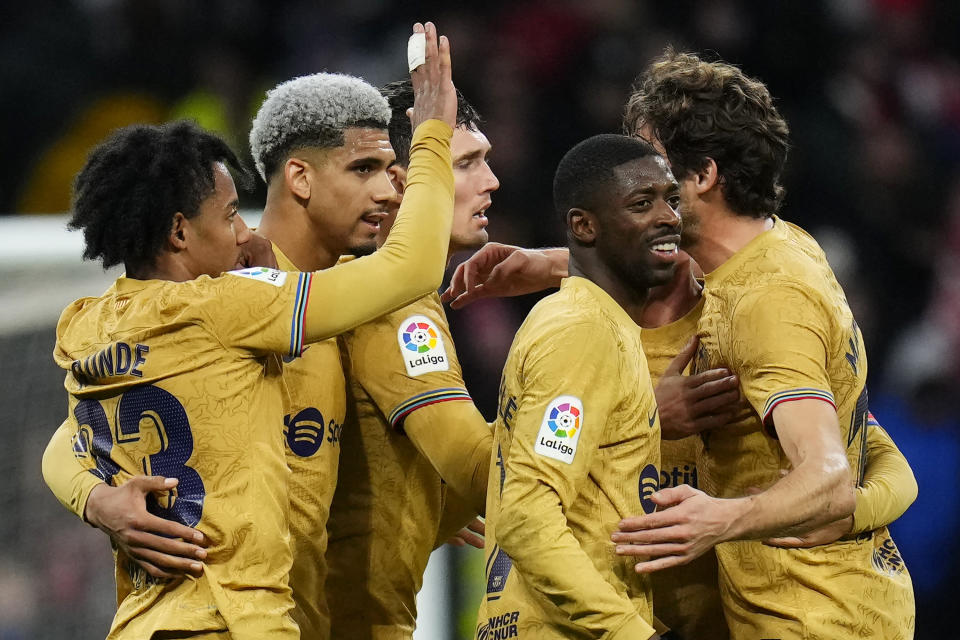 Barcelona's Ousmane Dembele, second from right, celebrates with teammates after the Spanish La Liga soccer match between Atletico Madrid and FC Barcelona at Civitas Metropolitano stadium in Madrid, Spain, Sunday, Jan. 8, 2023. (AP Photo/Manu Fernandez)