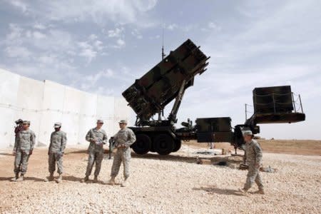FILE PHOTO: U.S. soldiers stand beside a U.S. Patriot missile system at a Turkish military base in Gaziantep, southeastern Turkey, October 10, 2014.. REUTERS/Osman Orsal
