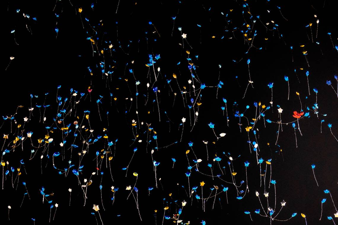 Balloons drift into the night sky after mourners released the balloons at the conclusion of a vigil Wednesday, Jan. 24, 2024 on the track of Charles T. Tucker Stadium at Smithfield-Selma High School in Johnston County. Five Smithfield-Selma students were memorialized including four boys who died in a car wreck early Monday morning.