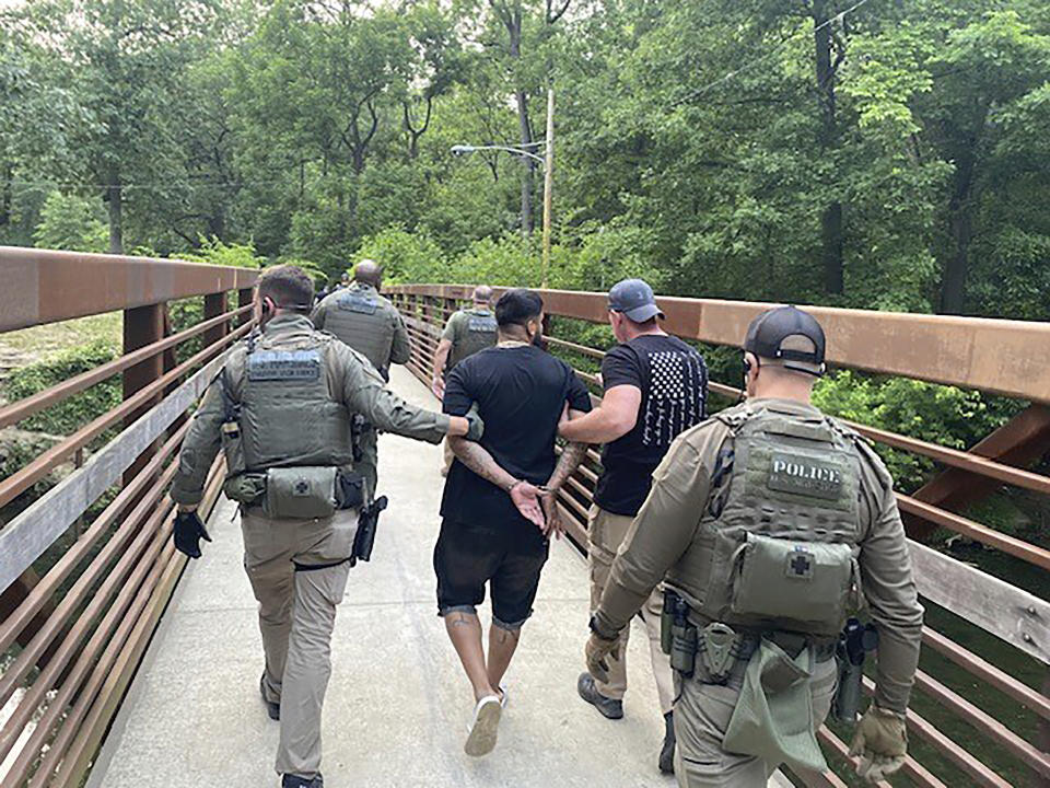 This photo provided by the U.S. Marshals Service shows officers arresting Ivan Claudio Rosero in Philadelphia, Tuesday, June 6, 2023. The fugitive wanted in the fatal shooting of three people, including two children who’d been playing with kittens in the back yard of their Pennsylvania home, has been captured in Philadelphia, federal officials said Wednesday. (U.S. Marshals Service via AP)