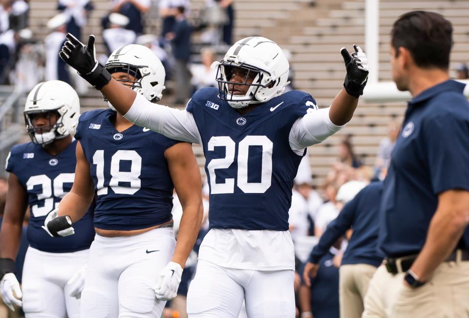 Penn State defensive end Adisa Isaac (20) enters the field with the rest of the defensive unit for team warmups before an NCAA football game against Indiana Saturday, Oct. 28, 2023, in State College, Pa. The Nittany Lions won, 33-24.