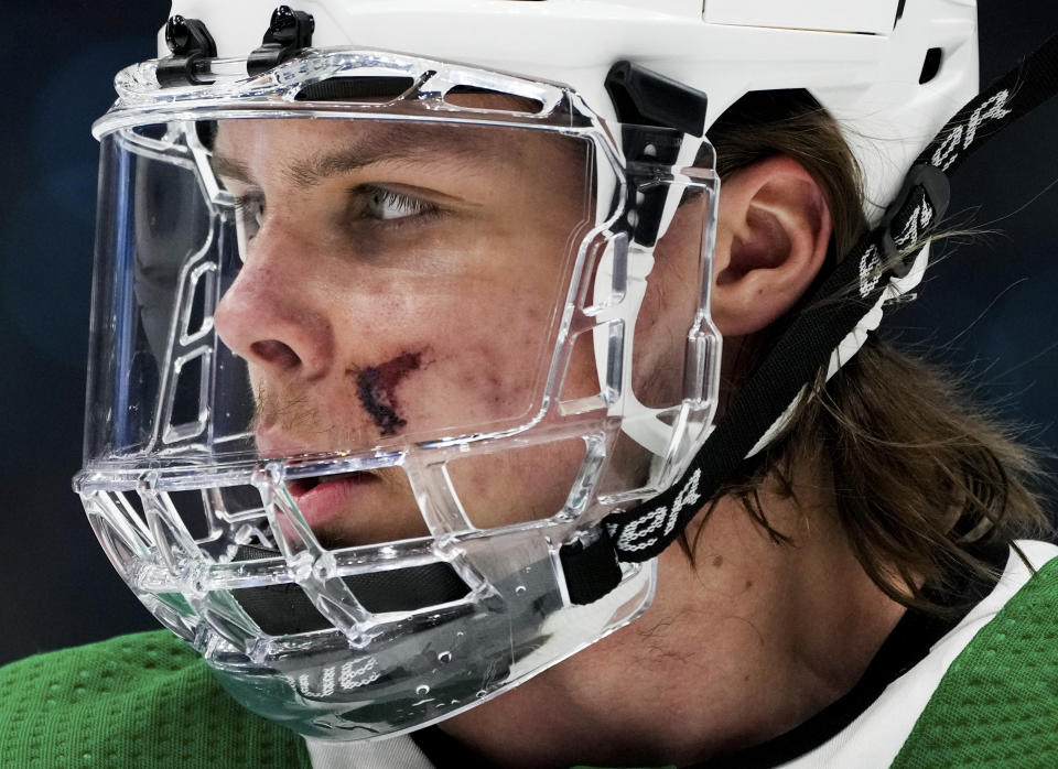 Dallas Stars defenseman Miro Heiskanen wears a face shield to protect stitches he received after being hit on the face by the puck in Game 3 against the Seattle Kraken, during the first period of Game 4 of an NHL hockey Stanley Cup second-round playoff series Tuesday, May 9, 2023, in Seattle. (AP Photo/Lindsey Wasson)