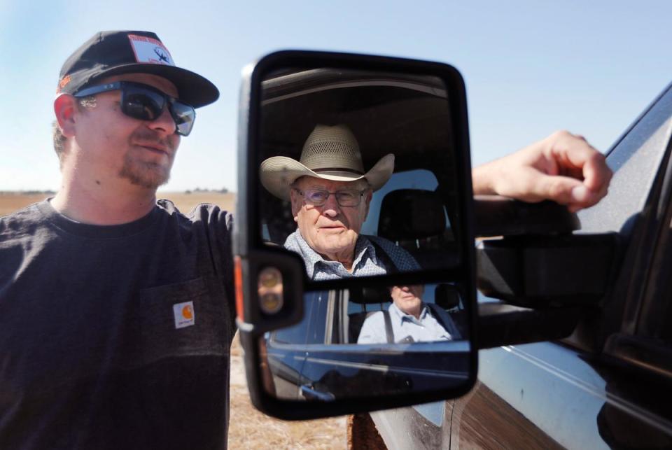 From left, Tanner Heffington talks to Jimmy Drake next to Drake’s truck outside of their shop. Drake passed on his farm and equipment to long time neighbor Heffington last year making this the first time in 71 years that a member of the Drake family didn’t harvest the land.