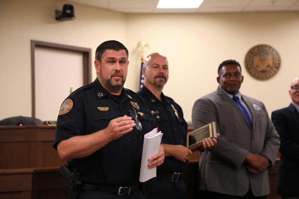 Columbia Police Chief Jeremy Alsup, left, shares words of acknowledgement to Assistant Police Chief Joey Gideon during his retirement presentation at City Council on Thursday, Aug. 11, 2022.