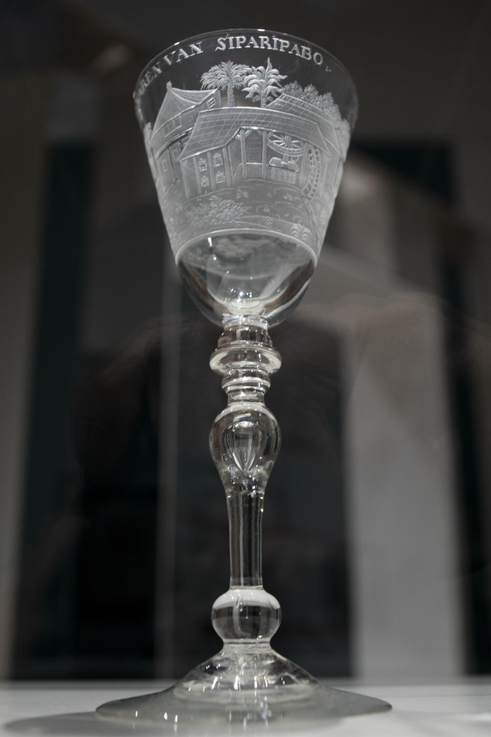 A ceremonial glass commissioned by plantation owners is seen at the Slavery exhibition at the Rijksmuseum in Amsterdam, Netherlands, Monday, May 17, 2021. The stark contrast between finery and brutality, wealth and inhumanity is a recurring pattern at the museum's unflinching new exhibition titled, simply, "Slavery", that examines the history of Dutch involvement in the international slave trade. (AP Photo/Peter Dejong)