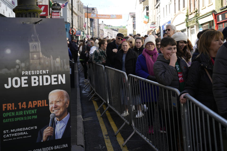 People queue to get into the staging area ahead of the visit by President Joe Biden to St Muredach's Cathedral, in Ballina, Ireland, Friday, April 14, 2023. The President will give a speech later Friday outside the cathedral.(AP Photo/Christophe Ena)