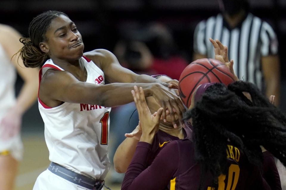 Maryland guard Diamond Miller, left, competes for a rebound with Minnesota forward Kadiatou Sissoko (30) and center Klarke Sconiers during the second half of an NCAA college basketball game, Saturday, Feb. 20, 2021, in College Park, Md. (AP Photo/Julio Cortez)