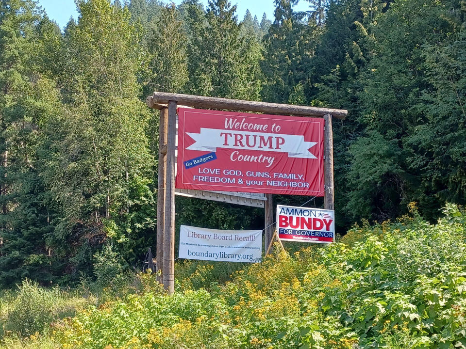 A sign demanding a recall of the library board hangs below a