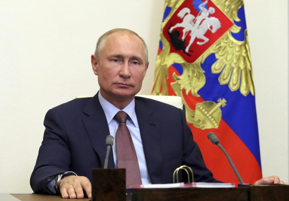 Russian President Vladimir Putin listens to French President Emmanuel Macron during a via video conference at the Novo-Ogaryovo residence outside Moscow, Russia, Friday, June 26, 2020. (Mikhail Klimentyev, Sputnik, Kremlin Pool Photo via AP)