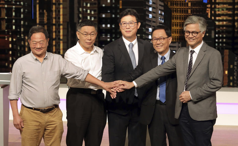 Candidates of Taipei mayoral election, from left, Li Hsi-kun, incumbent mayor Ko Wen-je, Pasuya Yao of Democratic Progressive Party, Ting Shou-chung of Nationalist Party and Wu E-yang, pose for a picture at the start of their televised policy debate in Taipei, Saturday, Nov. 10, 2018. Li and Wu are independent candidates. The candidates vying to become the mayor of Taiwan’s capital, Taipei, faced off in a televised debate on Saturday, two weeks before a host of local elections seen as a barometer of the ruling party’s popularity. (Pool Photo via AP)