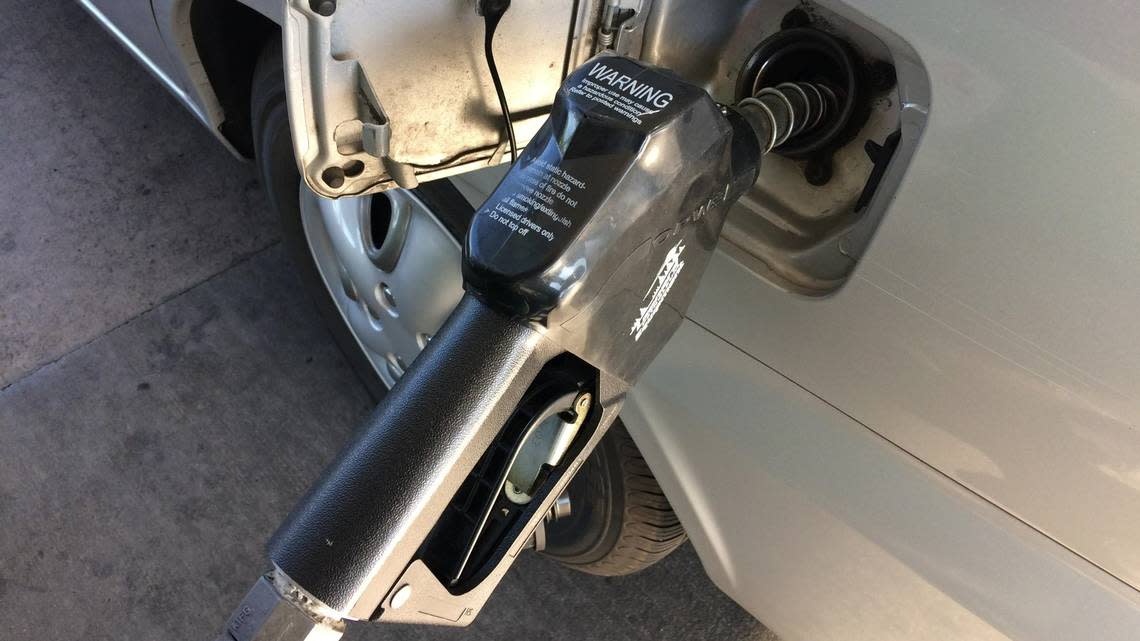 Gasoline pump with handle dispenses fuel into car. Stock, generic. Boise, Idaho, Aug. 31, 2019.