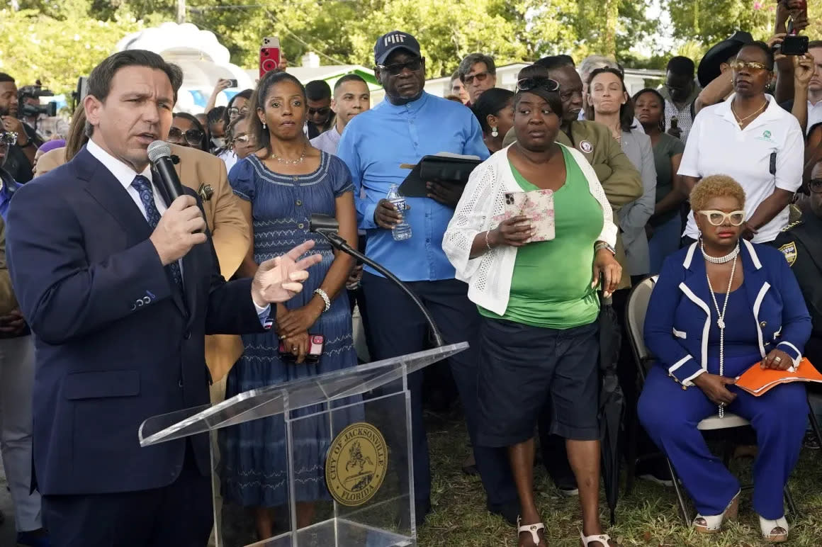 Gov. Ron DeSantis speaks Aug. 27 at a vigil for three Black people killed the day before in Jacksonville. In what has been labeled a racist attack, a white man gunned down the victims in a Dollar General.