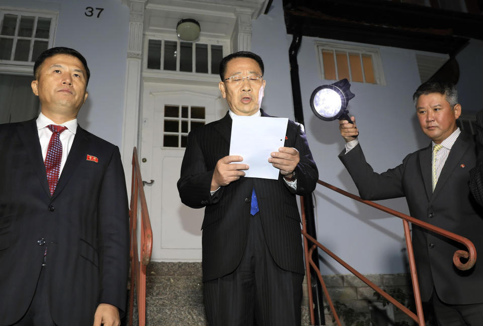 North Korean negotiator Kim Miyong Gil, center, reads statement outside the North Korean Embassy in Stockholm, Sweden, Saturday, Oct. 5, 2019. North Korea's chief negotiator said Saturday that discussions with the U.S. on Pyongyang's nuclear program have broken down, but Washington said the two sides had "good discussions" that it intends to build on in two weeks. (Kyodo News via AP)