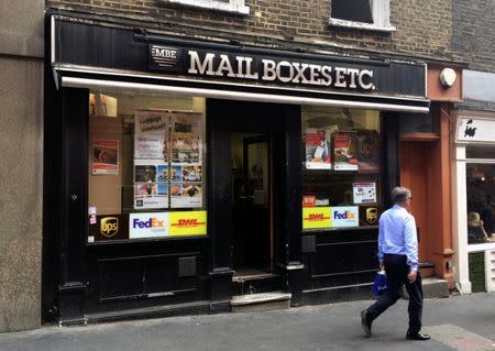 A man walks past a branch of Mail Boxes Etc. at 43 Bedford Street in London, Britain, August 25, 2016. REUTERS/Tom Bergin