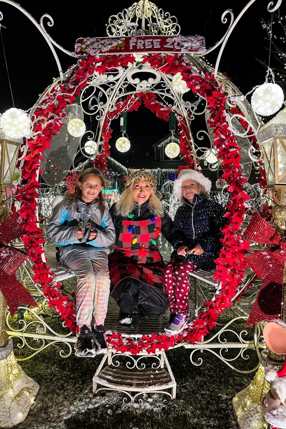 Cheryl Underwood, center, poses with two young visitors to her holiday lights display outside her home on Friday, Dec.16, 2022, on Damon Road in Williamstown Township.
(Photo: Provided photo)