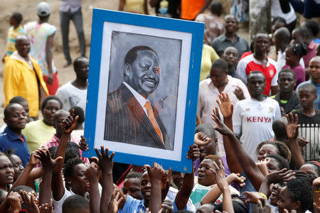 Supporters of opposition leader Raila Odinga hold his picture during a rally in the Mathare slum in Nairobi, Kenya, August 13, 2017. REUTERS/Siegfried Modola NO RESALES. NO ARCHIVES