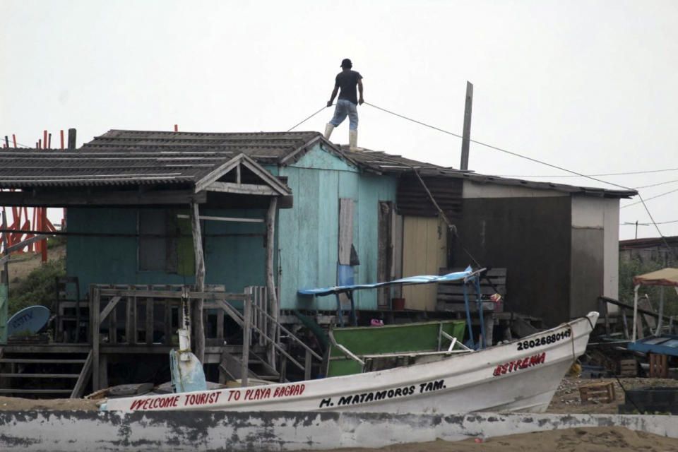 A man secures his home before the arrival of Tropical Storm Alberto.