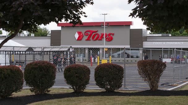 PHOTO: People work in the parking lot of the Tops Friendly Market, July 14, 2022, in Buffalo, N.Y.  (Joshua Bessex/AP)