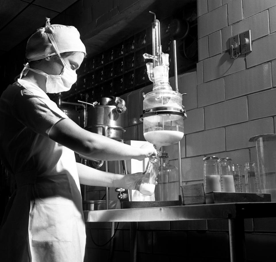 A lab technician fills a bottle with infant formula circa 1948 in Brooklyn, N.Y.