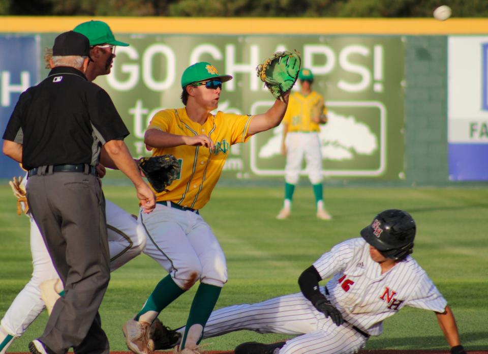 New Deal's Tyler Bigham (center) tries to stop New Home's Ashton Lucio from stealing second during their Region I-2A quarterfinal baseball series at Hays Field at Lubbock Christian University on Friday, May 20, 2022.