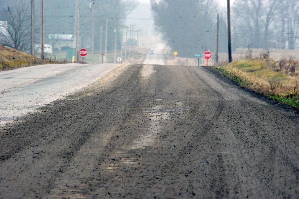The road is covered with mud hours after trucks were backed up on Pleasant Home Road outside of Wiles Storage Pond.