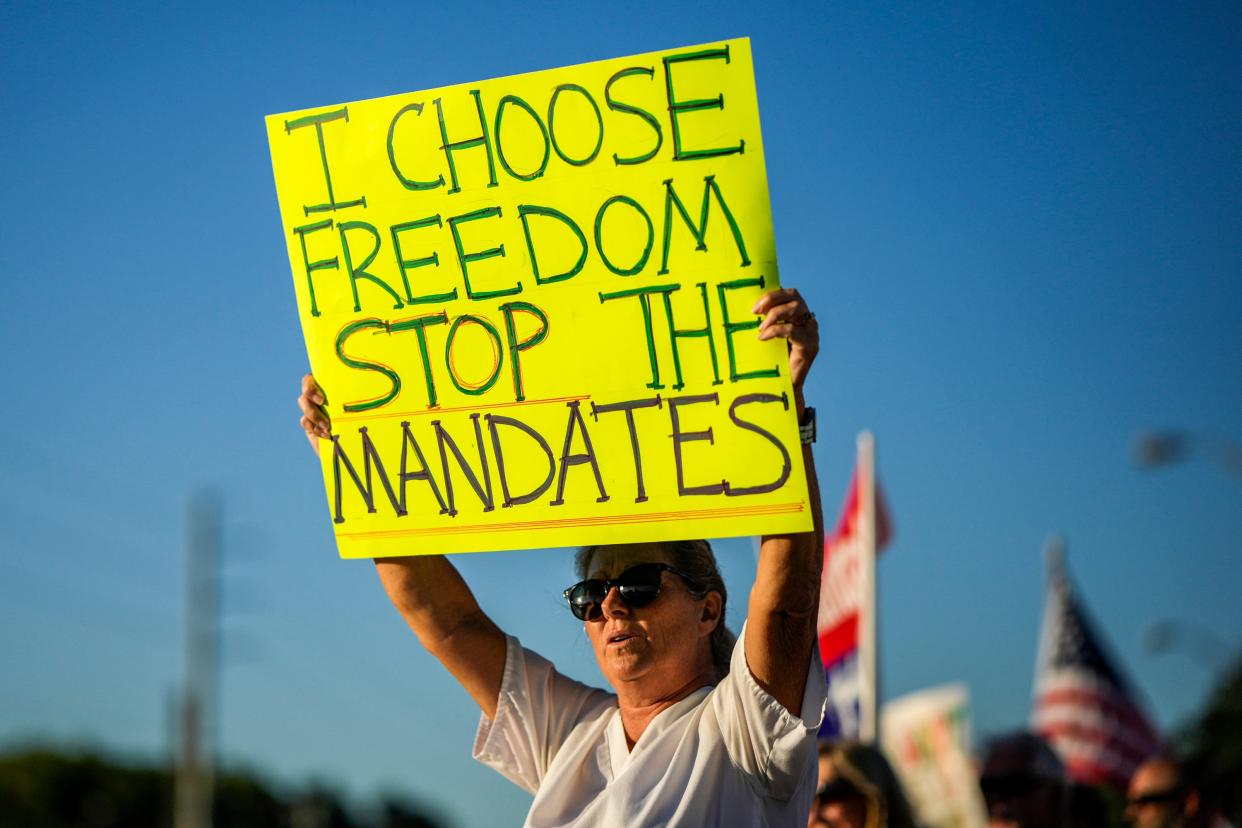 Tammy Rubino, of Stuart, protests on the Roosevelt Bridge against the federal COVID-19 vaccine mandate on Friday, Nov. 26, 2021, in Stuart. "I'm a 36-year veteran nurse and I'll lose my job in 10 days," said Rubino. The protest was in support of healthcare workers who will face unemployment because of the mandate.