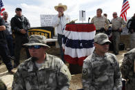 Rancher Cliven Bundy, middle, addresses his supporters along side Clark County Sheriff Doug Gillespie, right, on April 12, 2014. Bundy informed the public that the BLM has agreed to cease the roundup of his family's cattle.(AP Photo/Las Vegas Review-Journal, Jason Bean)