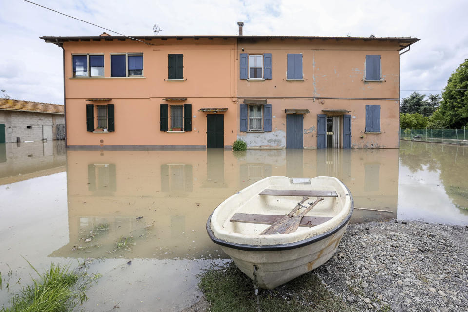 Water surround a house in the area near Bologna, Italy, Thursday, May 18, 2023. Rescue crews worked Thursday to reach towns and villages in northern Italy that were cut off from highways, electricity and cell phone service following heavy rains and flooding, as farmers warned of “incalculable” losses and authorities began mapping out cleanup and reconstruction plans. (Guido Calamosca/LaPresse via AP)