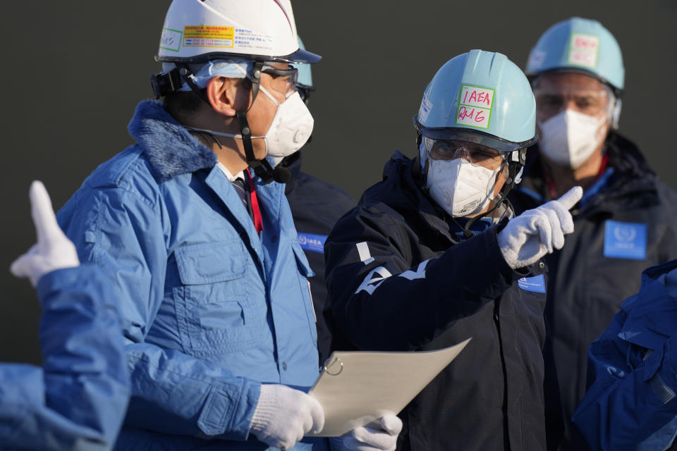 International Atomic Energy Agency Director General Rafael Mariano Grossi, right, and Tokyo Electric Power Co. (TEPCO) President Tomoaki Kobayakawa, left, speak at a facility for the sampling treated and diluted radioactive water to sea from the Fukushima Daiichi nuclear power plant, operated by TEPCO, in Futaba town, northeastern Japan, Wednesday, March 13, 2024. (AP Photo/Eugene Hoshiko, Pool)