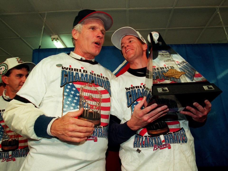 Ted Turner, as Atlanta Braves owner, stands with Tom Glavine, as Atlanta Braves pitcher (l-r), who holds the series MVP trophy after winning World Series, photo