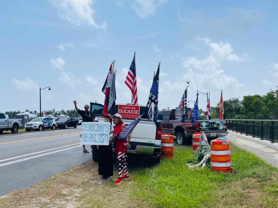 Trump supporter holds a "Democrats are fascists" sign outside Mar-a-Lago.