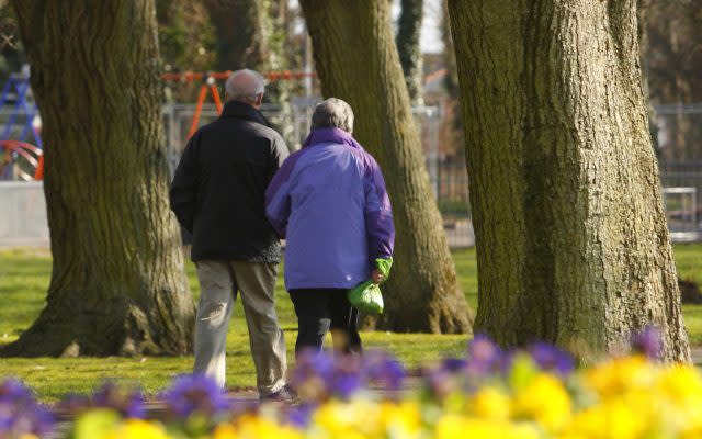 Couple walking through a park