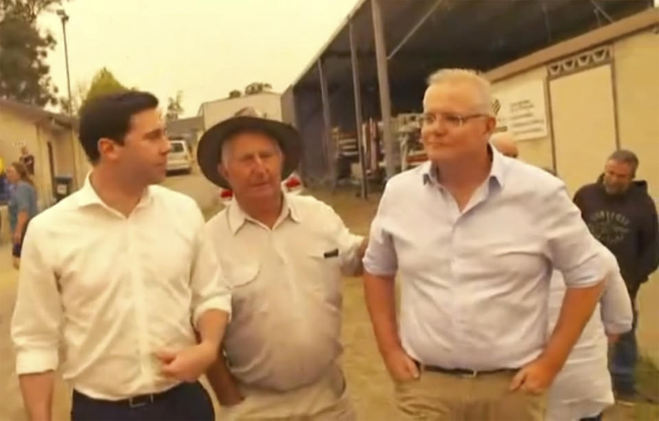 Australian Prime Minister Scott Morrison, right, visits the wildfire-ravaged town of Cobargo. (AuBC via AP)