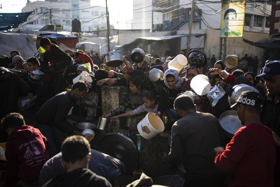 Palestinians line up for a free meal in Rafah, Gaza Strip, on Tuesday, March 12, 2024. (AP Photo/Fatima Shbair)