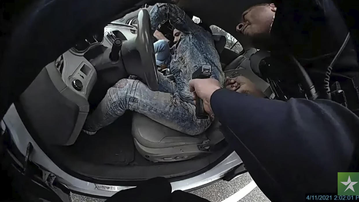 Daunte Wright is seen in the driver’s seat of a car during the fatal traffic stop. A gun held by a police officer can be seen pointing at him.