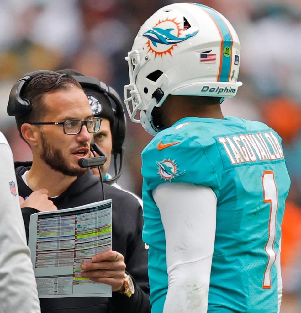 Miami Dolphins head coach Mike McDaniel talks with Miami Dolphins quarterback Tua Tagovailoa (1) in the second quarter during the game against the Green Bay Packers at Hard Rock Stadium in Miami Gardens, Florida on Sunday, December 25, 2022.