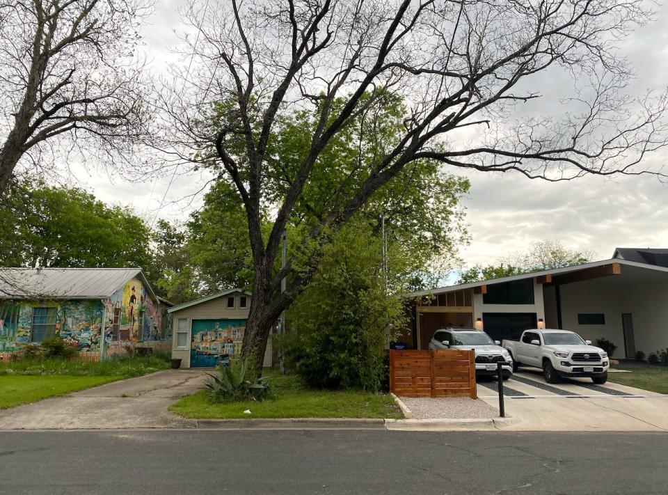 An older home next to a new single-family home in Austin, Texas.