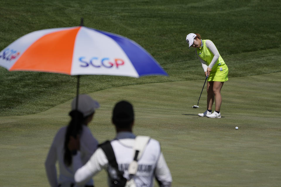Ayaka Furue putts on the first green as Pajaree Anannarukarn and her caddy watch during the final day of the LPGA Bank of Hope Match Play golf tournament Sunday, May 28, 2023, in North Las Vegas, Nev. (AP Photo/John Locher)