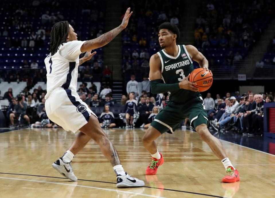 Michigan State guard Jaden Akins looks to pass the ball as Penn State guard Ace Baldwin Jr defends during the second half of MSU's 80-72 win on Wednesday, Feb. 14, 2024, in University Park, Pennsylvania.