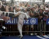 Formula One F1 - U.S. Grand Prix - Circuit of the Americas, Austin, Texas, U.S., 23/10/16. Mercedes' Lewis Hamilton of Britain celebrates his victory with members of his crew after the race. REUTERS/Adrees Latif