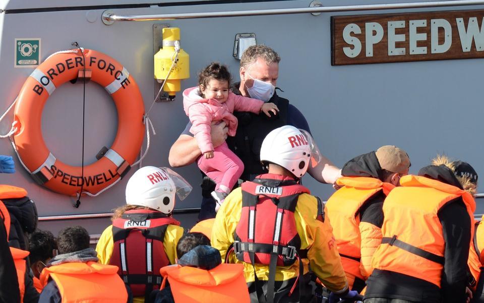 Young girl with border force officials - Steve Finn