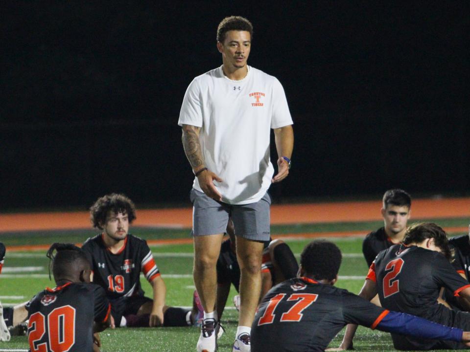 Taunton coach Jesue Lopes (center) speaks with his players following a Hockomock League game against Sharon.