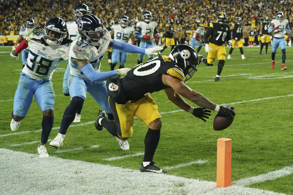 Pittsburgh Steelers running back Jaylen Warren (30) steps out of bounds short of the goal line as he runs past Tennessee Titans safeties Amani Hooker (37) and Terrell Edmunds (38) during the second half of an NFL football game Thursday, Nov. 2, 2023, in Pittsburgh. (AP Photo/Matt Freed)