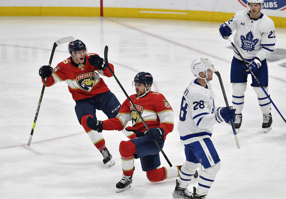 Florida Panthers center Sam Reinhart, center, celebrates scoring the game-winning goal against the Toronto Maple Leafs during overtime of Game 3 of an NHL hockey Stanley Cup second-round playoff series, Sunday, May 7, 2023, in Sunrise, Fla. (AP Photo/Michael Laughlin)