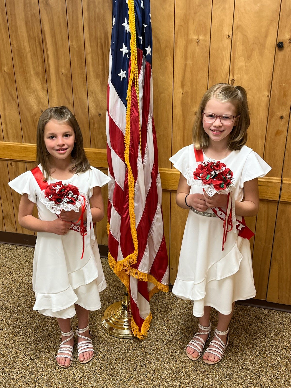 Representing Harry Higgins Post 88 of the American Legion as poppy girls are Little Miss Poppy Abigail Valentine and Miss Poppy Rosemary Valentine. Parents are Ben and Toni Valentine of Wooster and grandparents are Stan and Sally Valentine of Ashland. Abigail, 6, is in first grade at Norwayne Local Schools. Rosemary, 9,  is in the fourth grade at Norwayne Local Schools. They will be riding in the City of Ashland Memorial Day parade and placing poppy bouquets at the veterans memorial during the service at Ashland Cemetery.